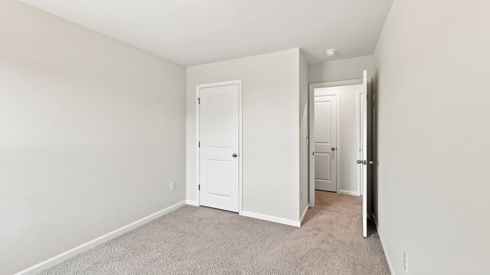 Bedroom with carpet and window.