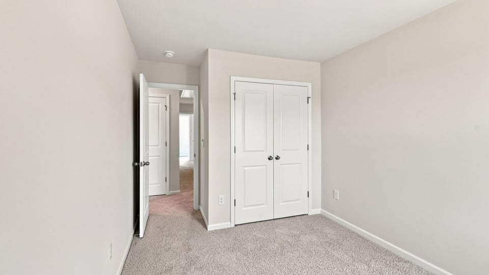 Bedroom with carpet and window.