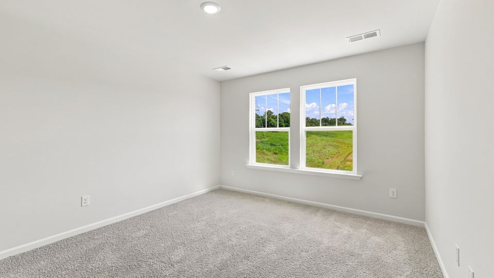 Bedroom with carpet and window.