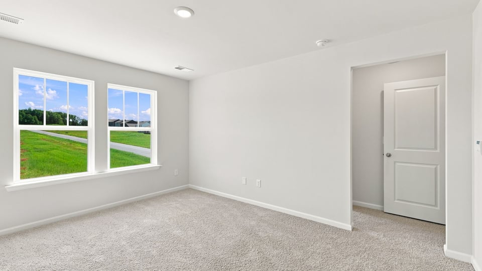 Bedroom with carpet and window.