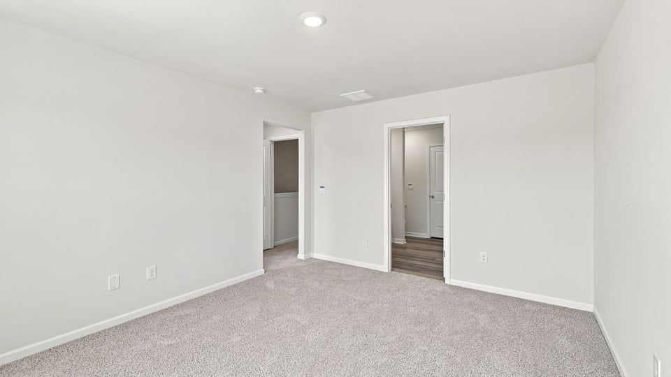 Bedroom with carpet and window.