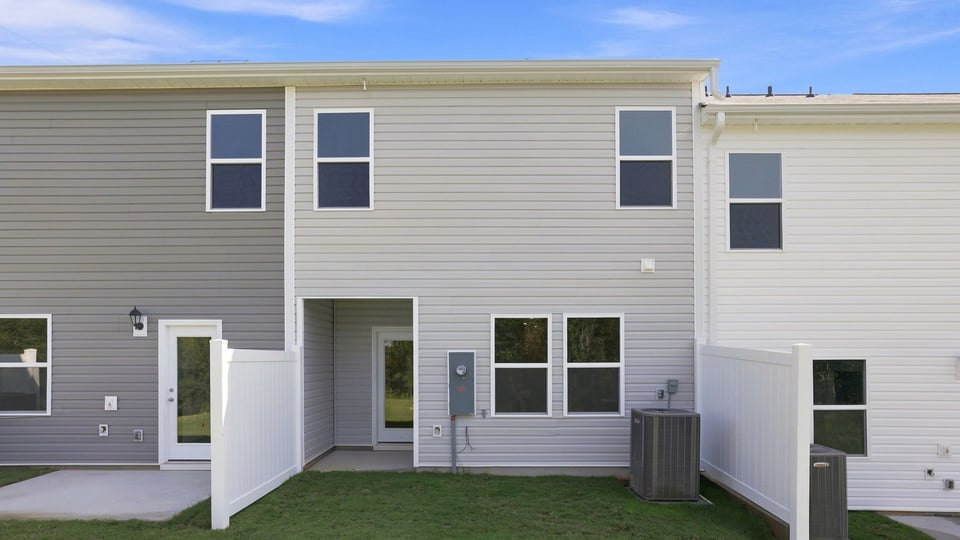 Back exterior of home with patio.