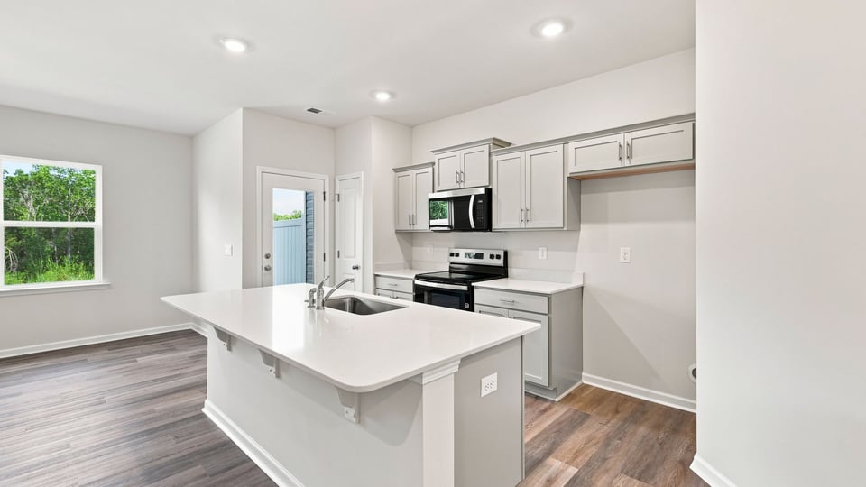 Kitchen with island and quartz countertops.
