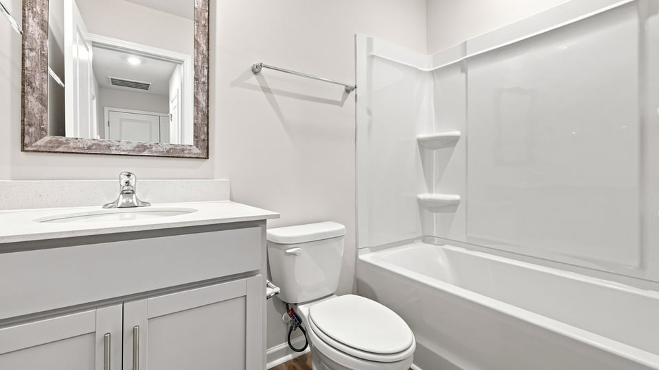 Bathroom with single vanity sink and bathtub.