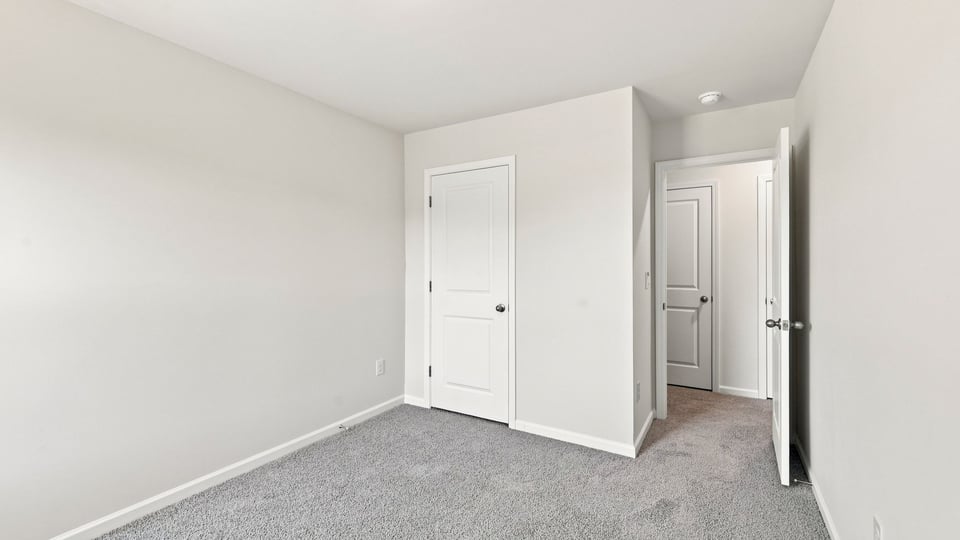 Bedroom with carpet and window.