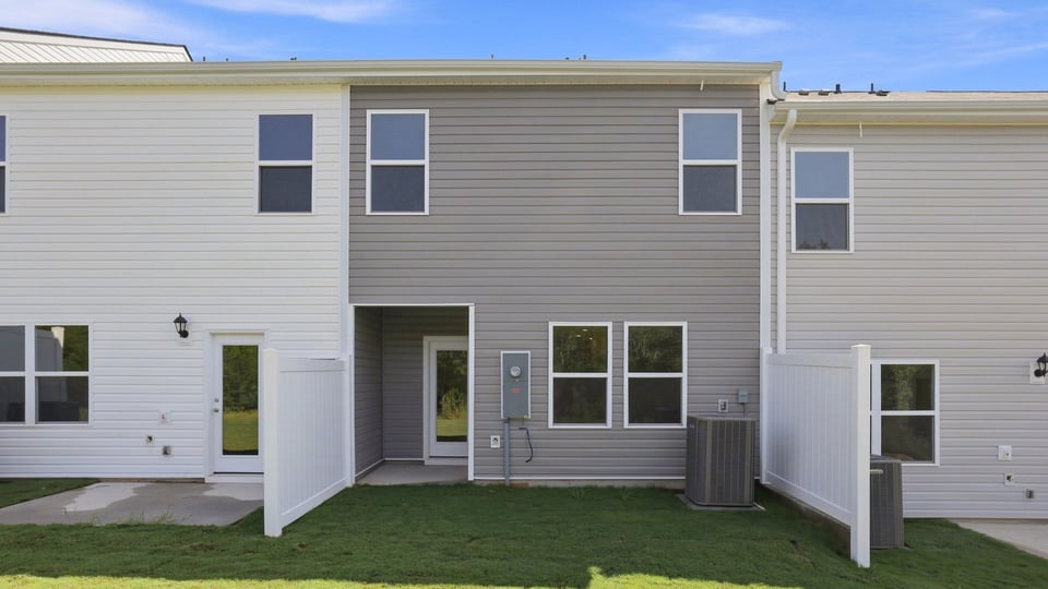 Back exterior of home with patio.