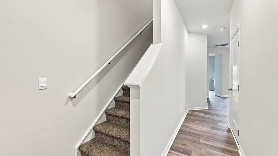 Hallway into home with view of rooms.