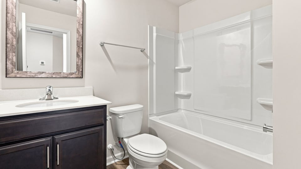 Bathroom with single vanity sink and bathtub.