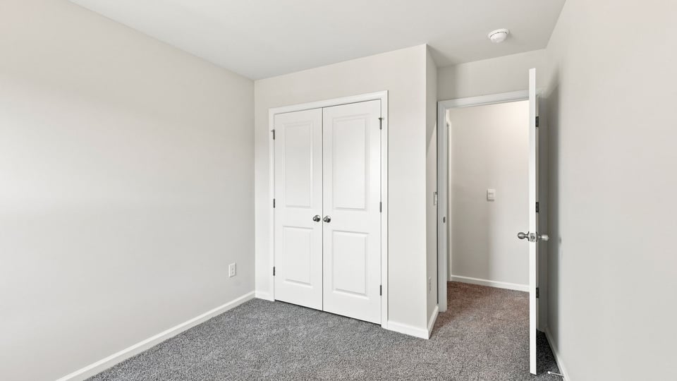 Bedroom with carpet and window.