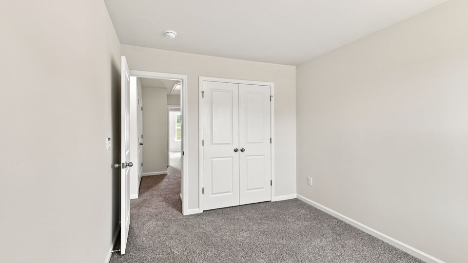 Bedroom with carpet and window.