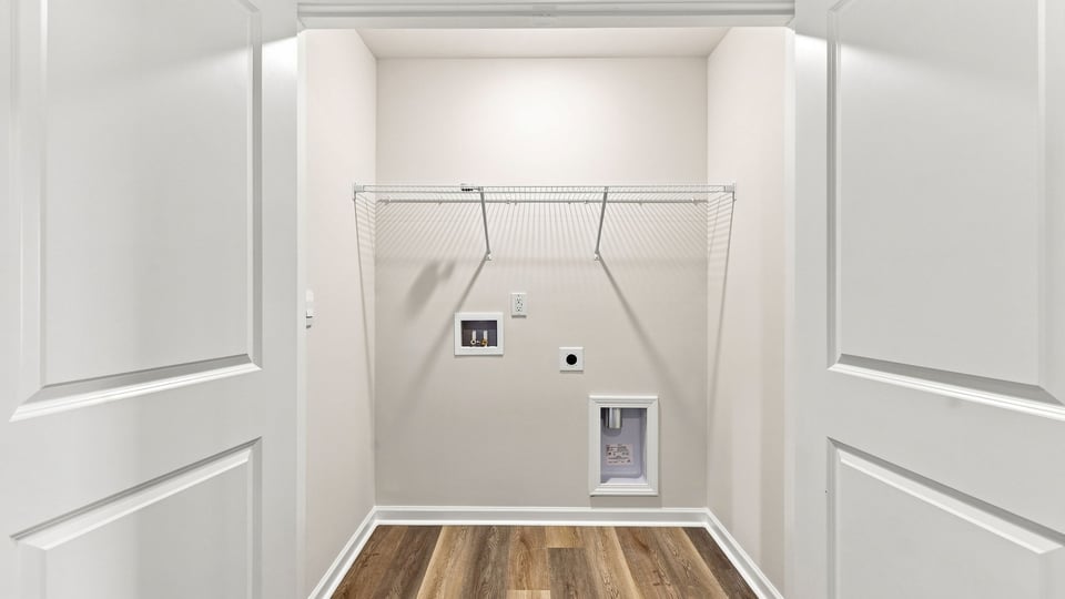 Laundry room with hanging storage racks.