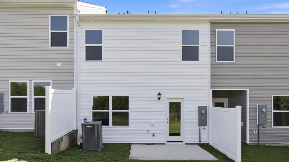 Back exterior of home with patio.