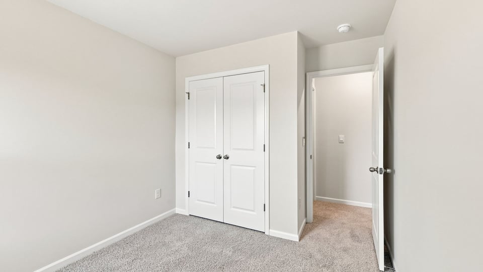 Bedroom with carpet and window.