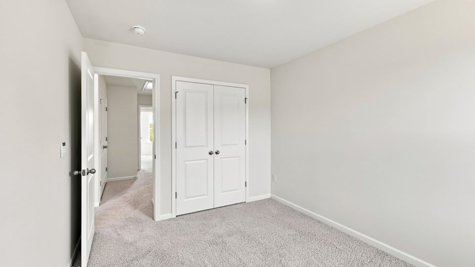 Bedroom with carpet and window.