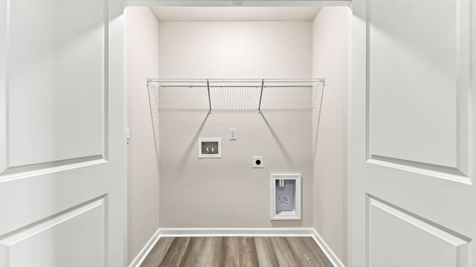 Laundry room with hanging storage racks.