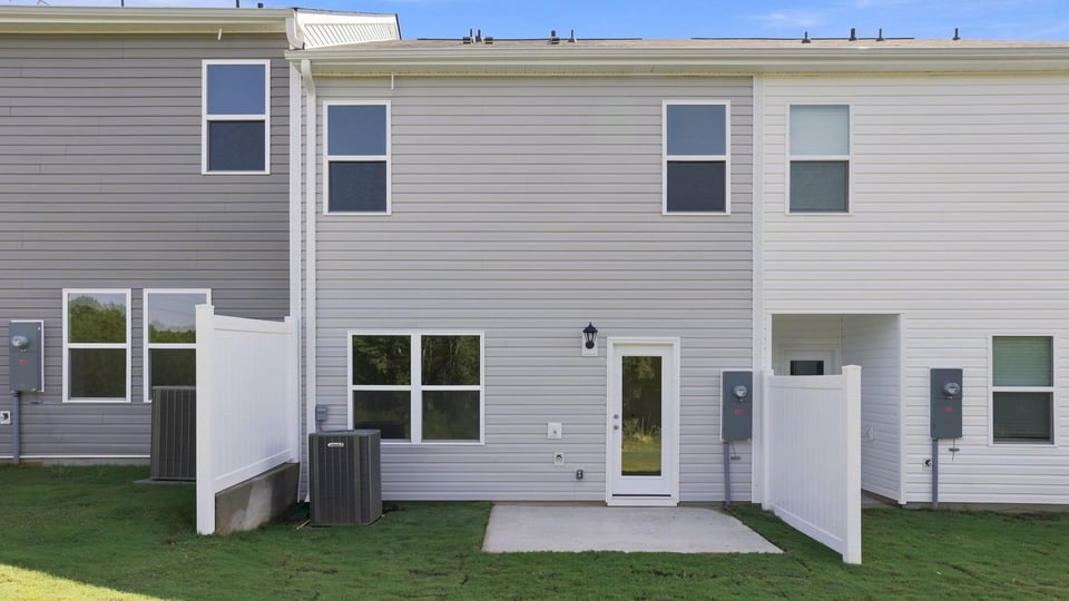 Back exterior of home with patio.