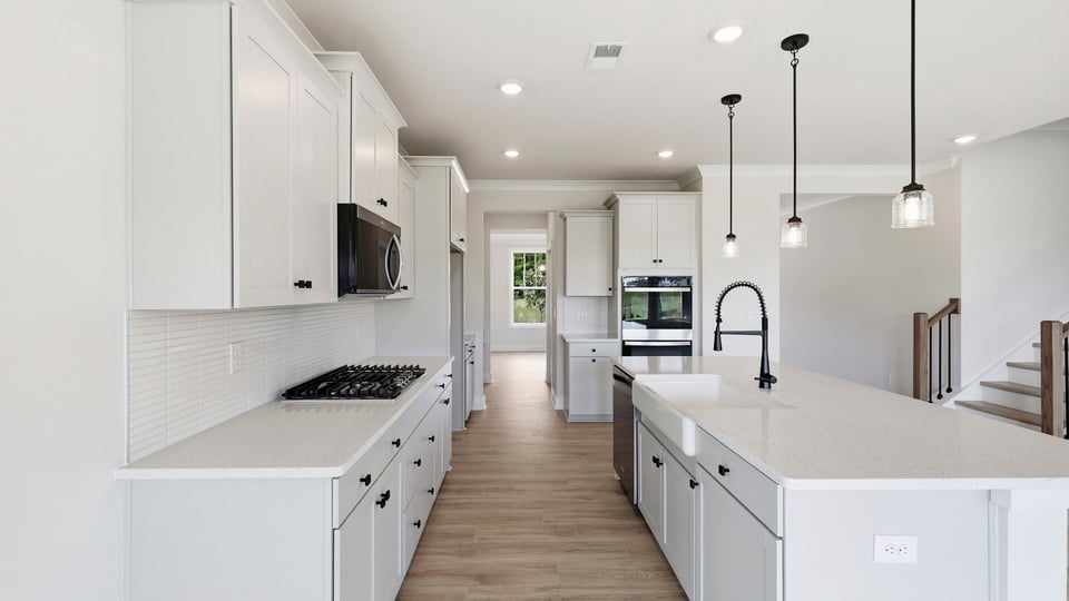 Kitchen and island with quartz countertops.