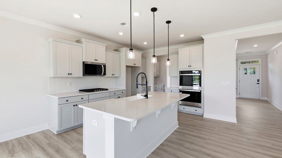 Kitchen and island with quartz countertops.