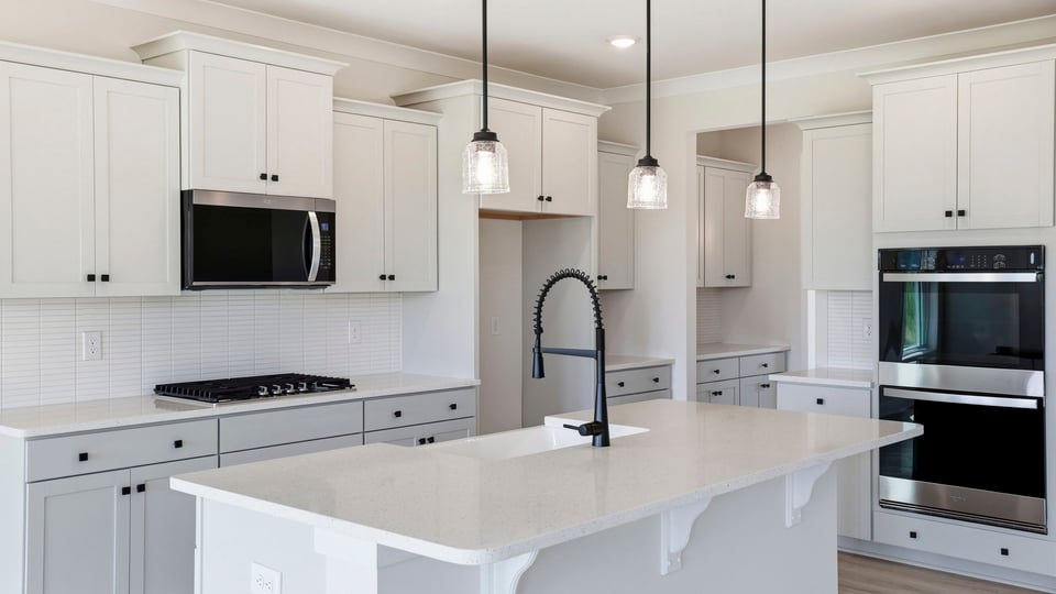 Kitchen and island with quartz countertops.