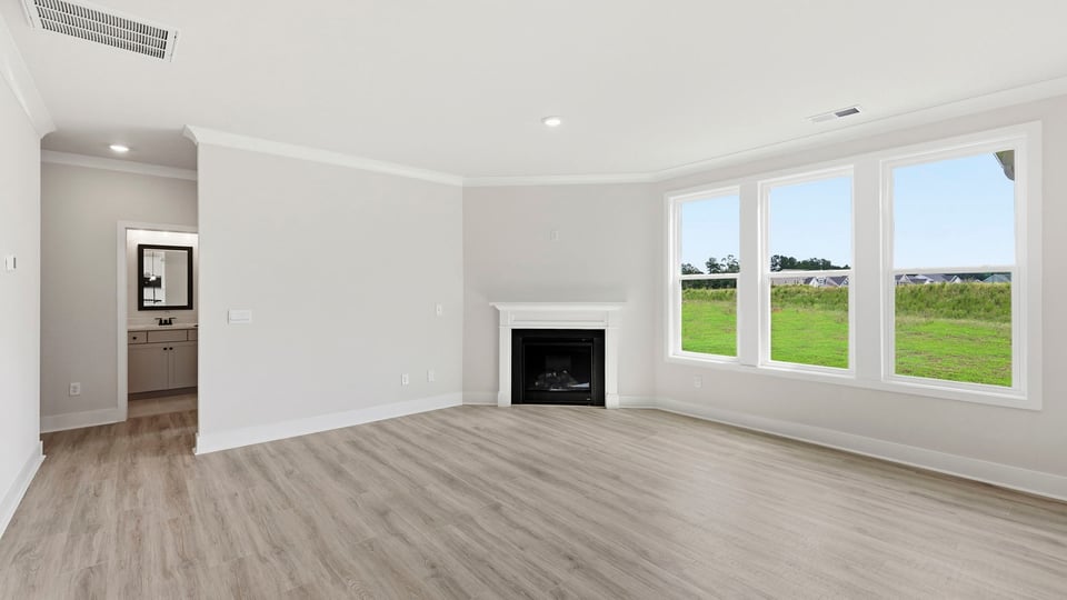 Living room with windows and fireplace.