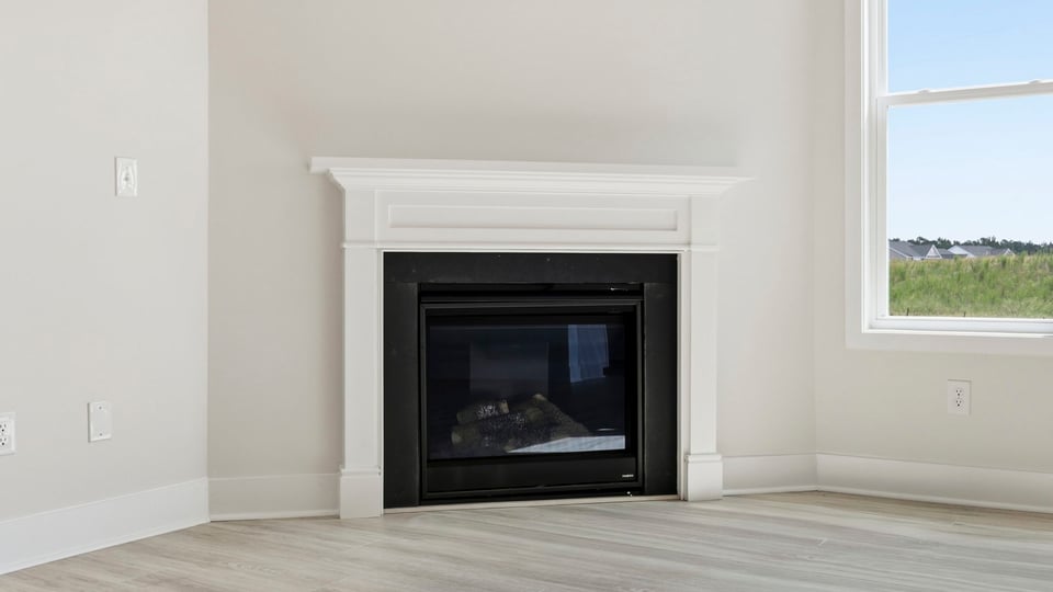 Living room with windows and fireplace.