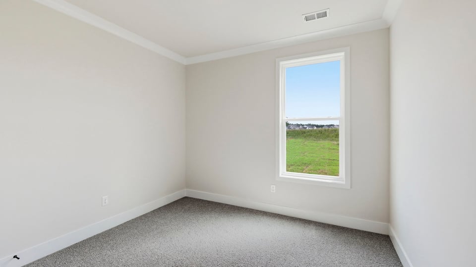 Bedroom with carpet and window.