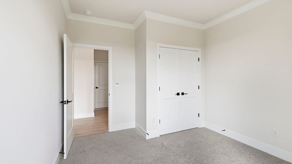 Bedroom with carpet and window.