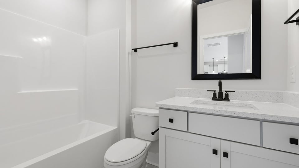 Bathroom with single vanity sink and bathtub.