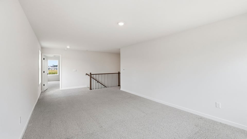 Loft area with carpet.