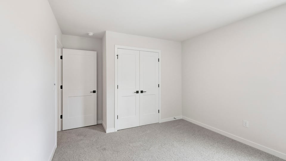 Bedroom with carpet and window.