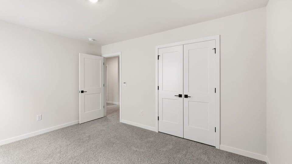 Bedroom with carpet and window.