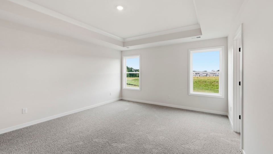 Bedroom with carpet and window.
