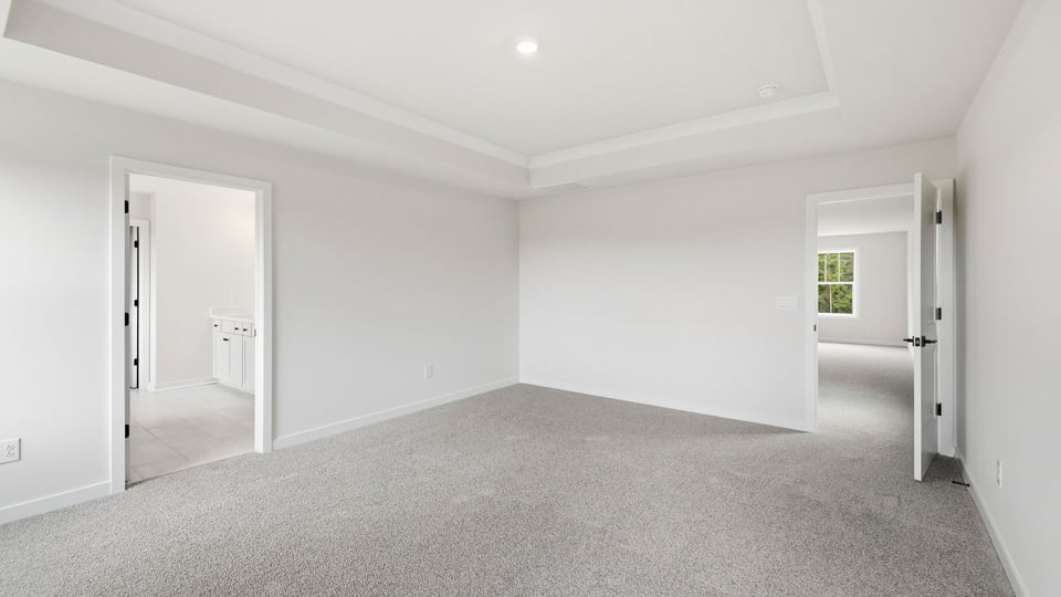 Bedroom with carpet and window.