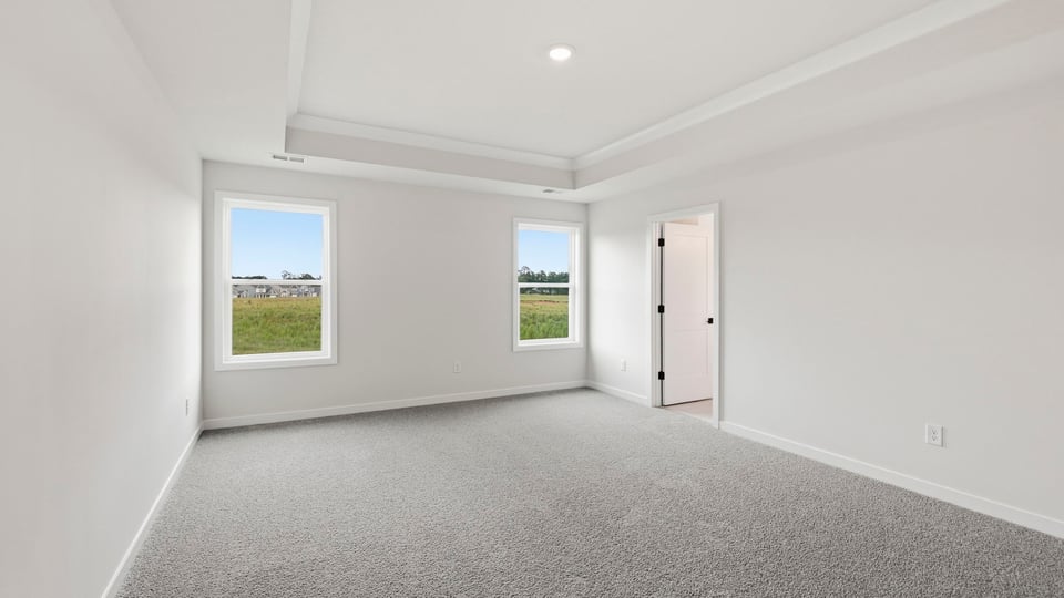 Bedroom with carpet and window.