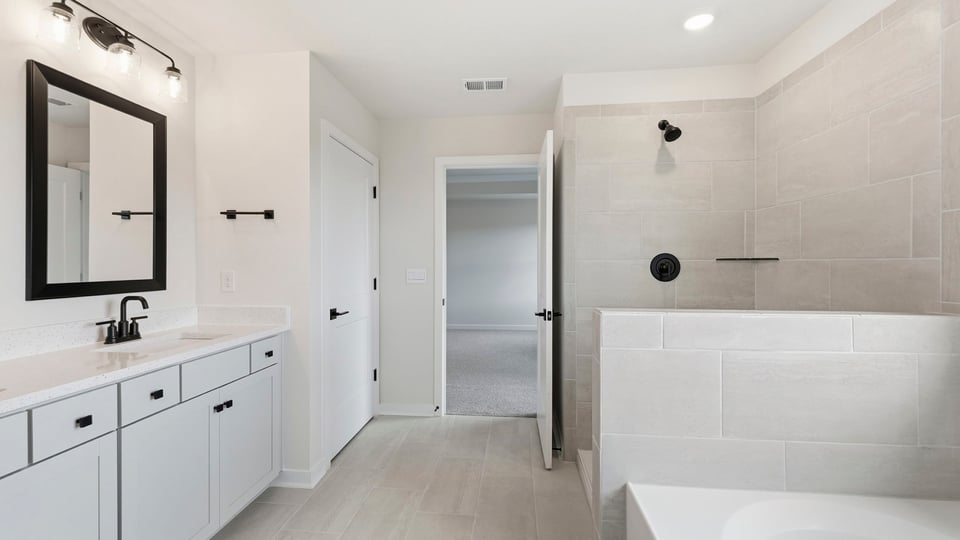 Bathroom with walk in shower and bathtub.