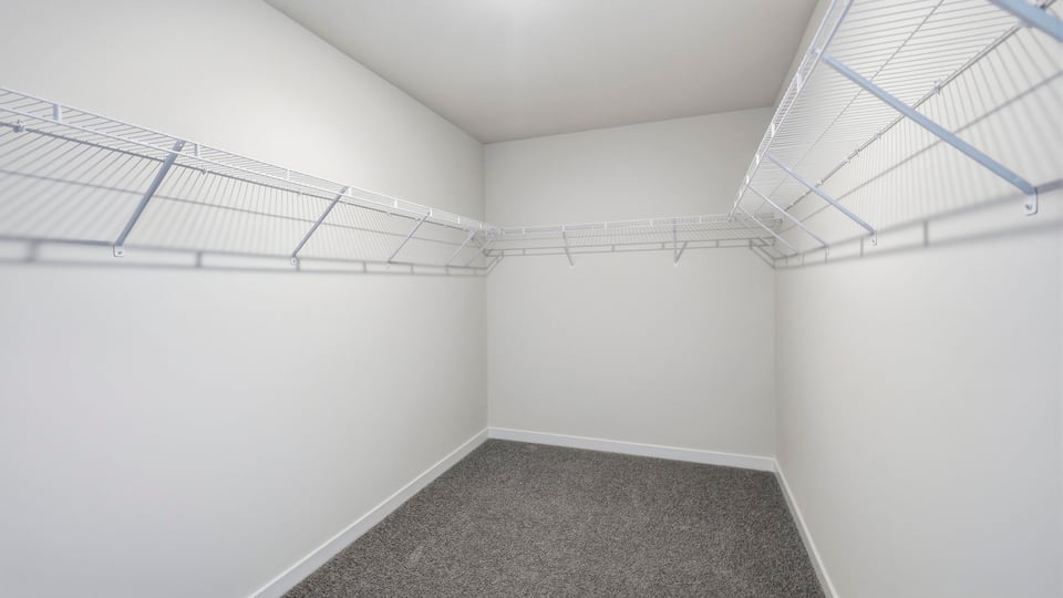 Closet with hanging storage racks.