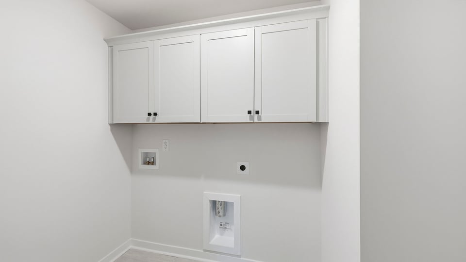 Laundry room with hanging storage racks.