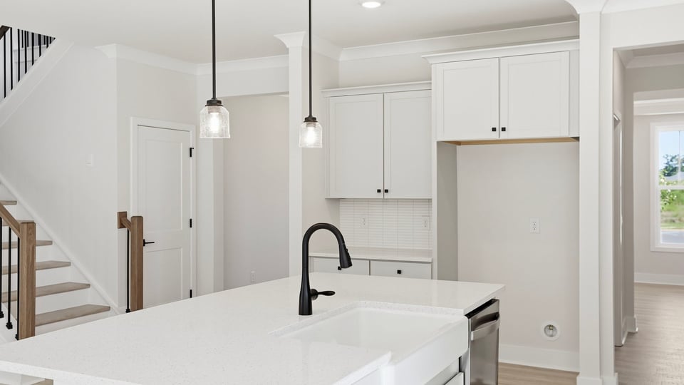 Kitchen and island with quartz countertops.