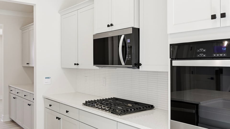Kitchen and island with quartz countertops.