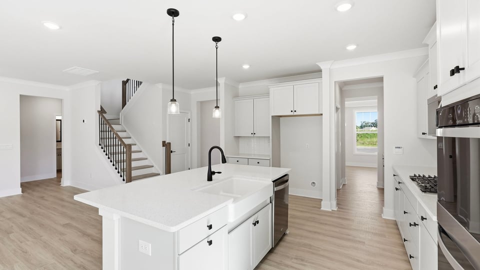 Kitchen and island with quartz countertops.