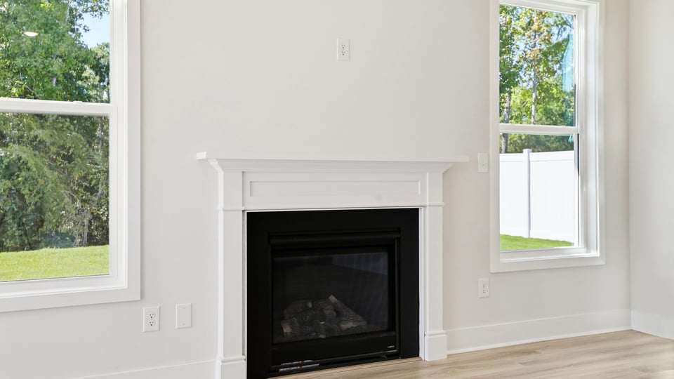 Living room with windows and fireplace.