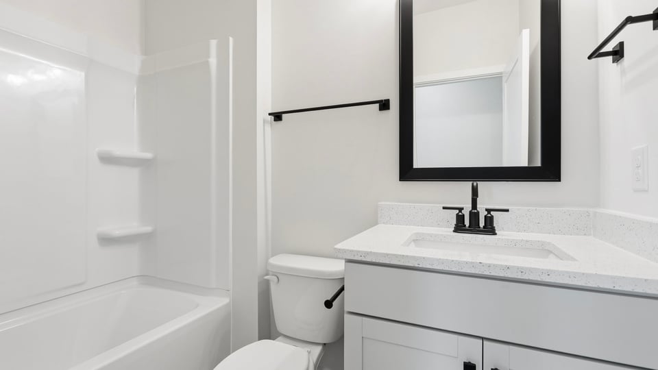 Bathroom with single vanity sink and bathtub.