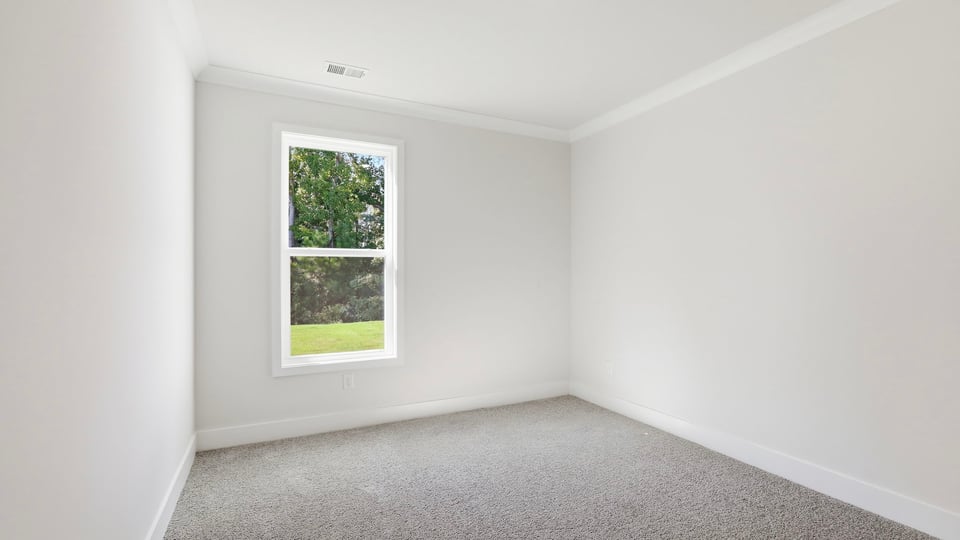 Bedroom with carpet and window.