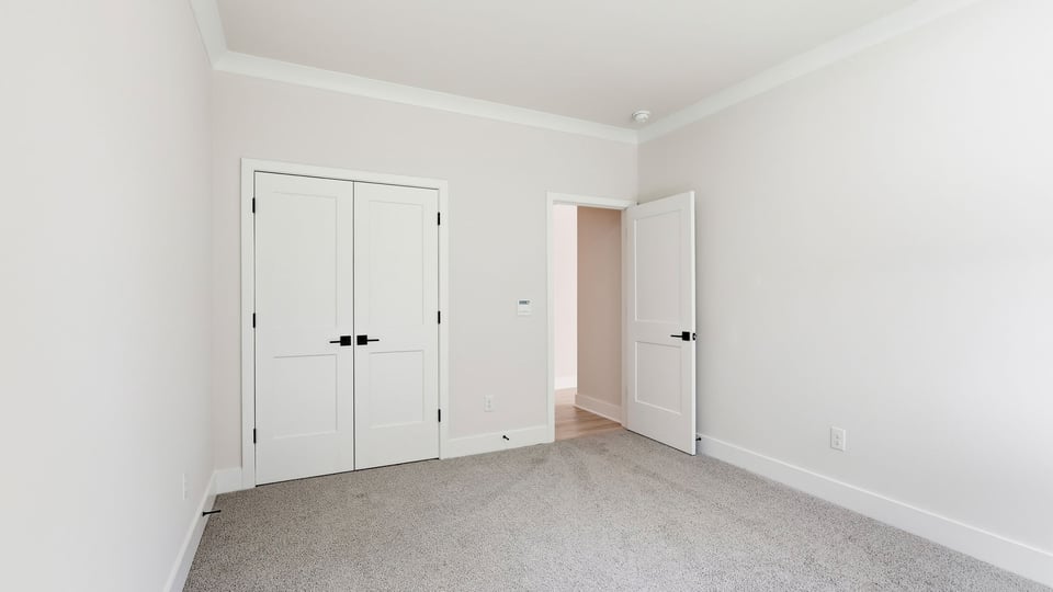 Bedroom with carpet and window.