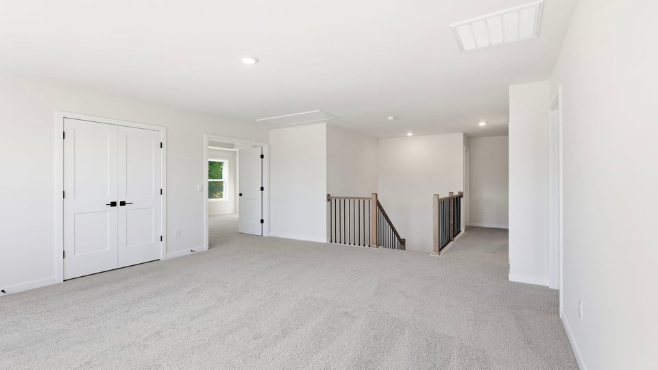 Loft with carpet and window.