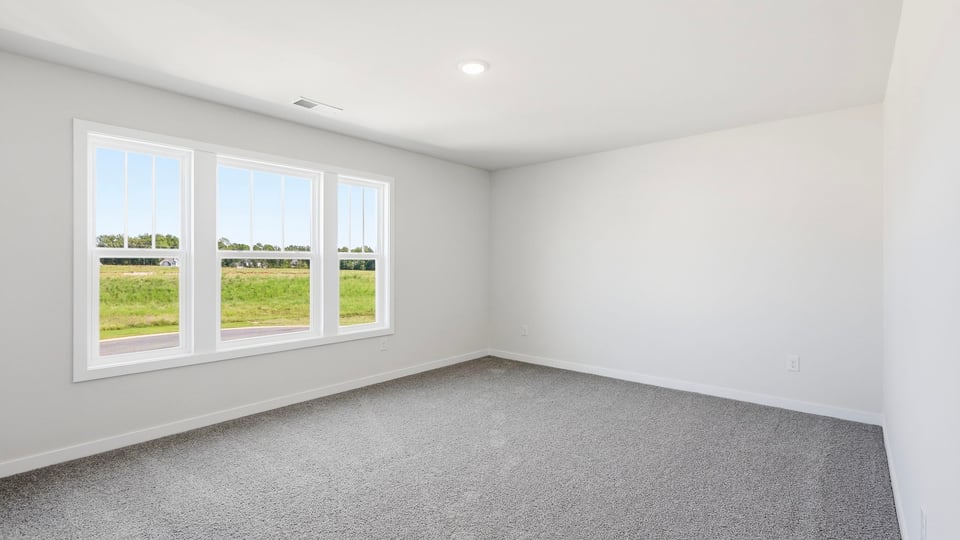 Loft with carpet and window.