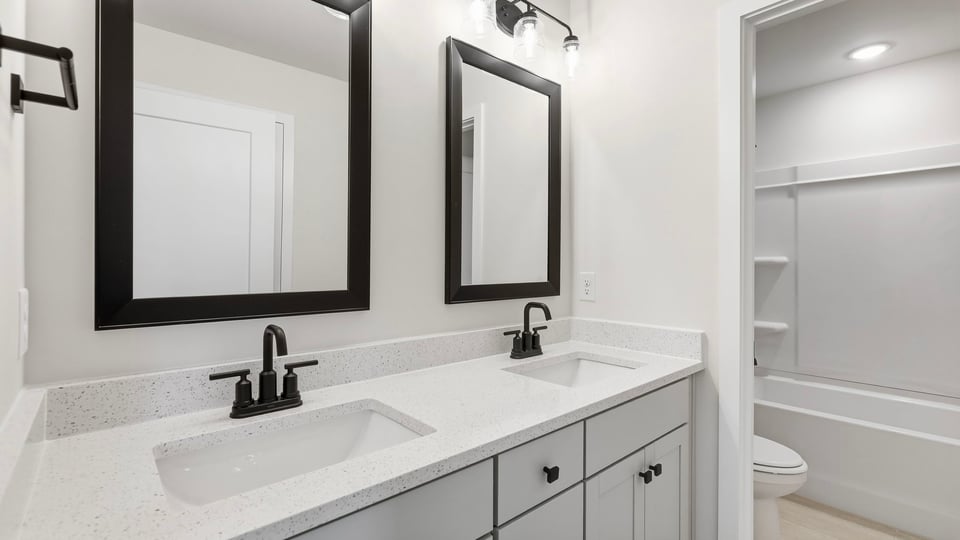 Bathroom with double vanity sink and bathtub.