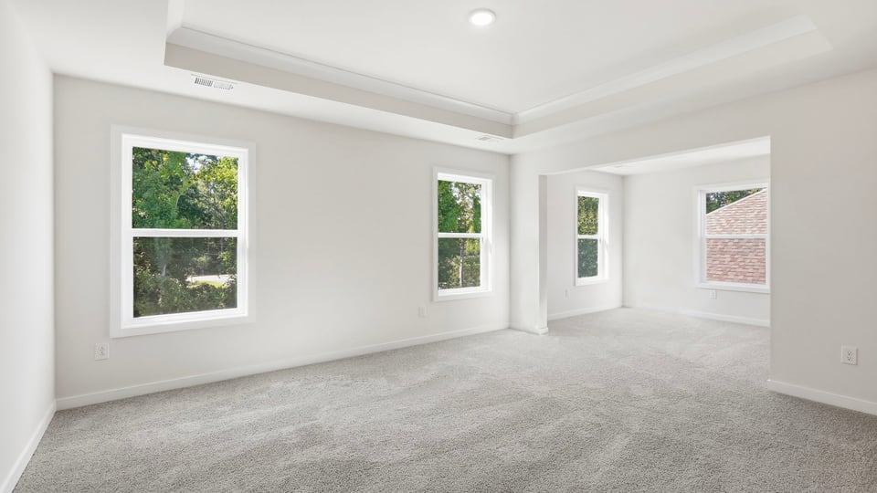 Bedroom with carpet and window.