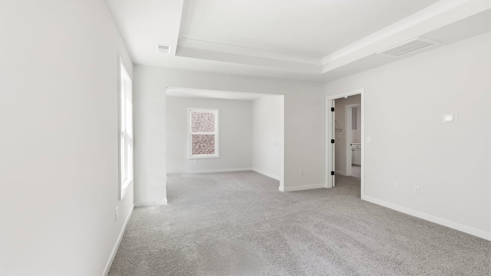 Bedroom with carpet and window.