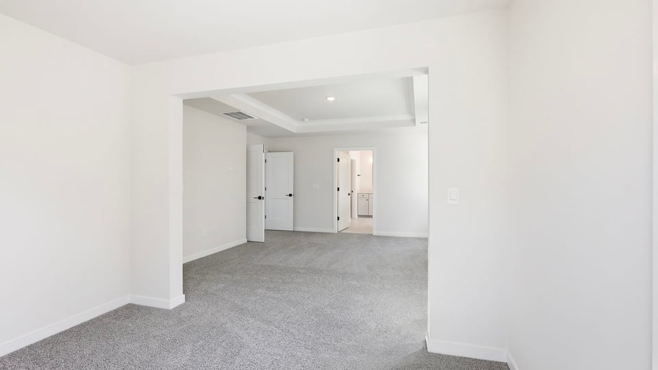 Bedroom with carpet and window.